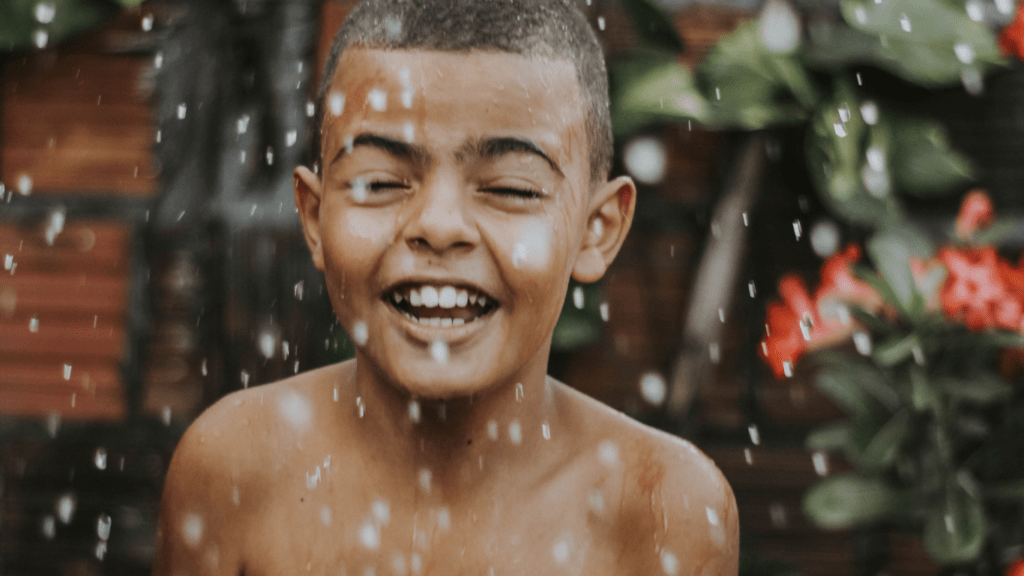 A child is playing in the rain