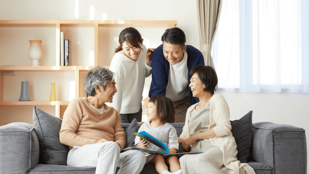 A family sitting on a couch in a living room