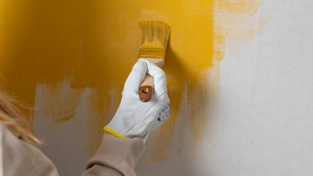 A person is painting a wall