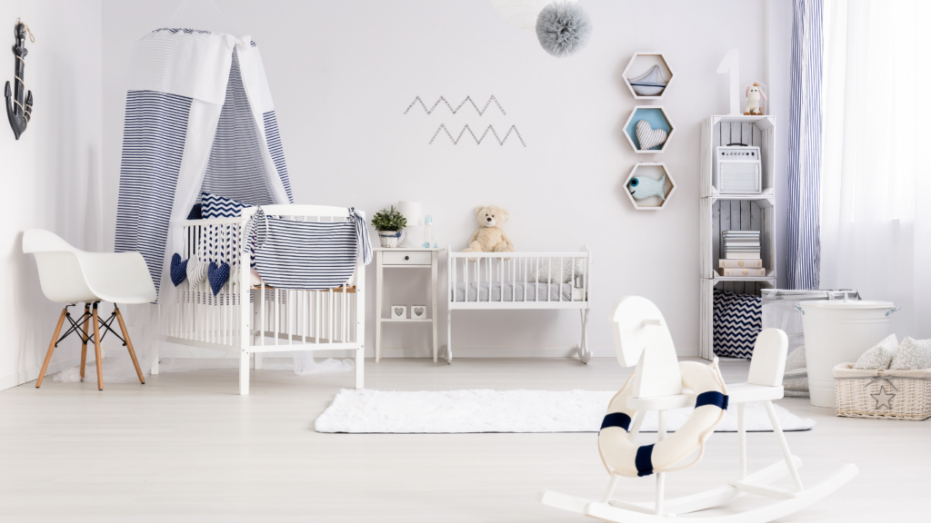 A white and blue nursery room with a rocking chair