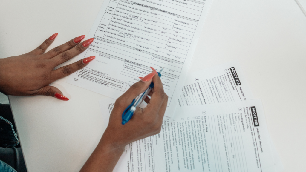 two people sitting at a table with a piece of paper in front of them