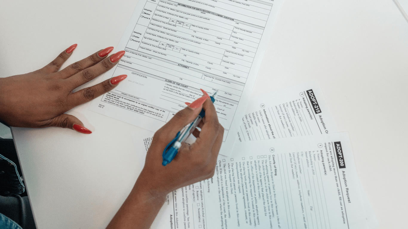 two people sitting at a table with a piece of paper in front of them
