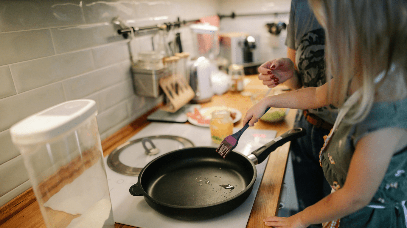 a person and child cooking in the kitchen