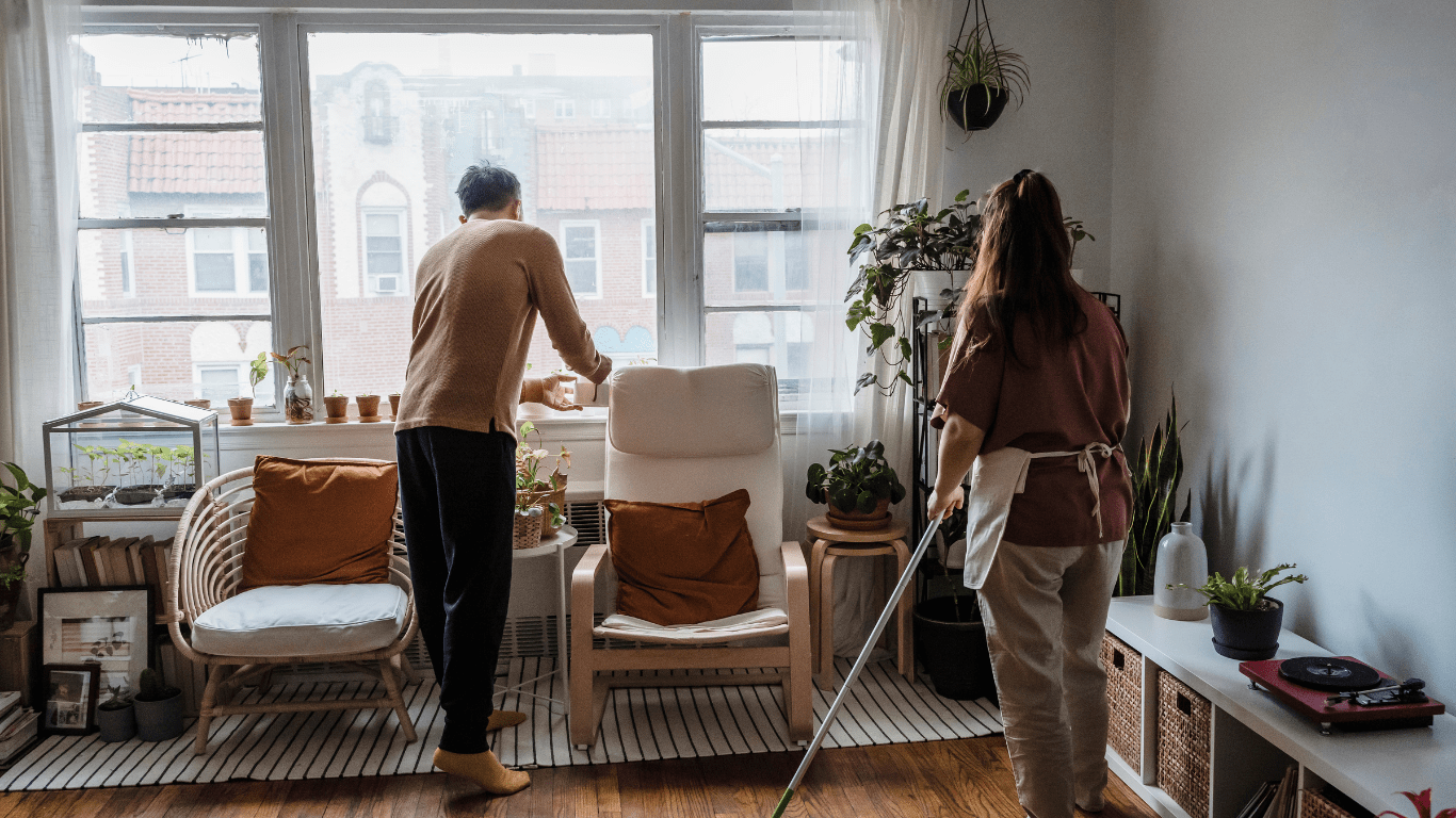 People cleaning hardwood floor in living room