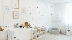 A white and blue nursery room with a rocking chair