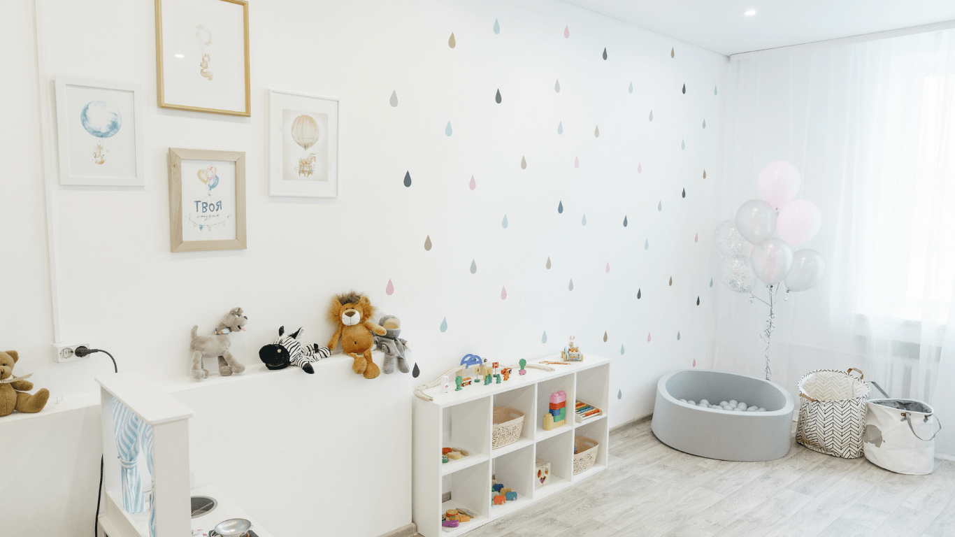 A white and blue nursery room with a rocking chair