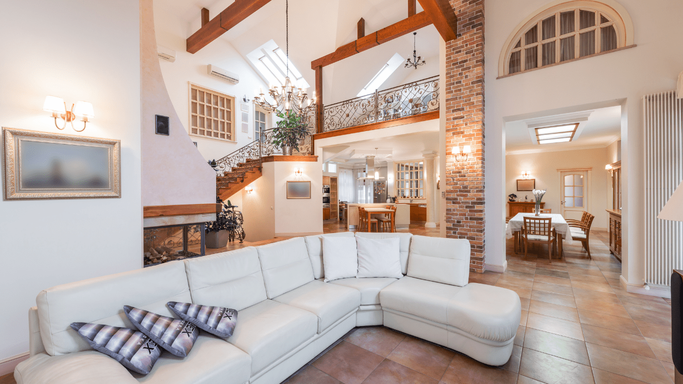 a living room with a ceiling fan and couches