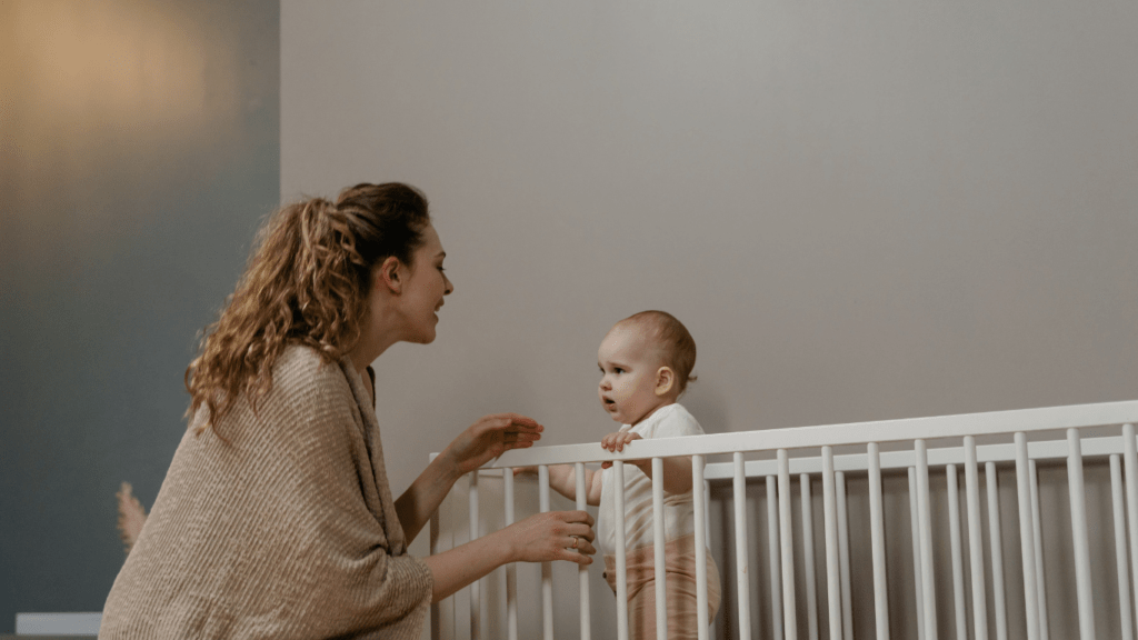 a person with a baby in a crib.png