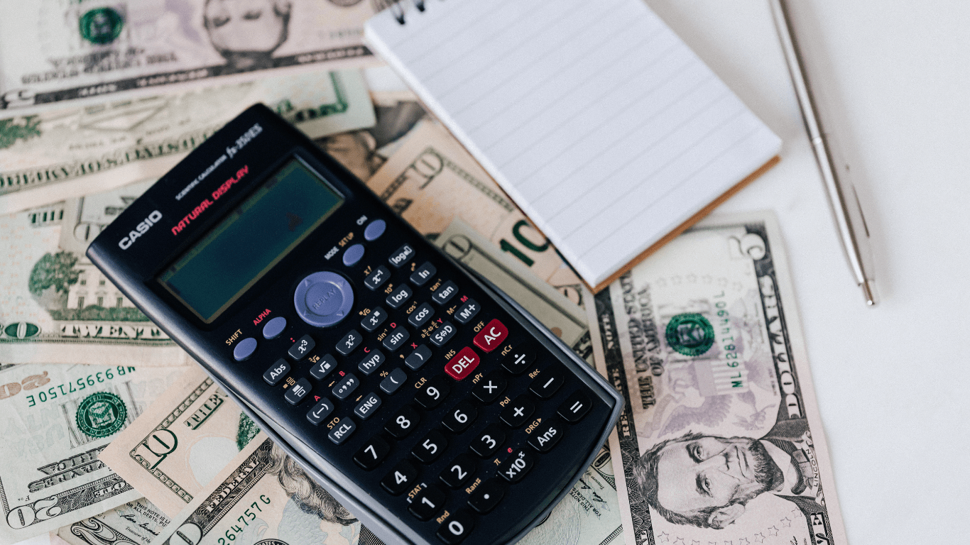 calculator and money on a desk