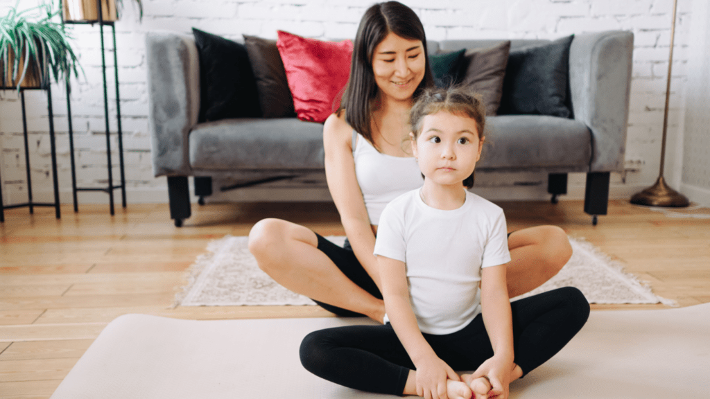 Mother and daughter doing yoga in the living room