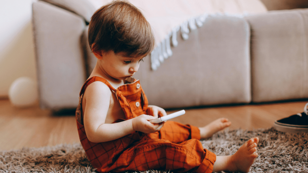 baby holding a phone