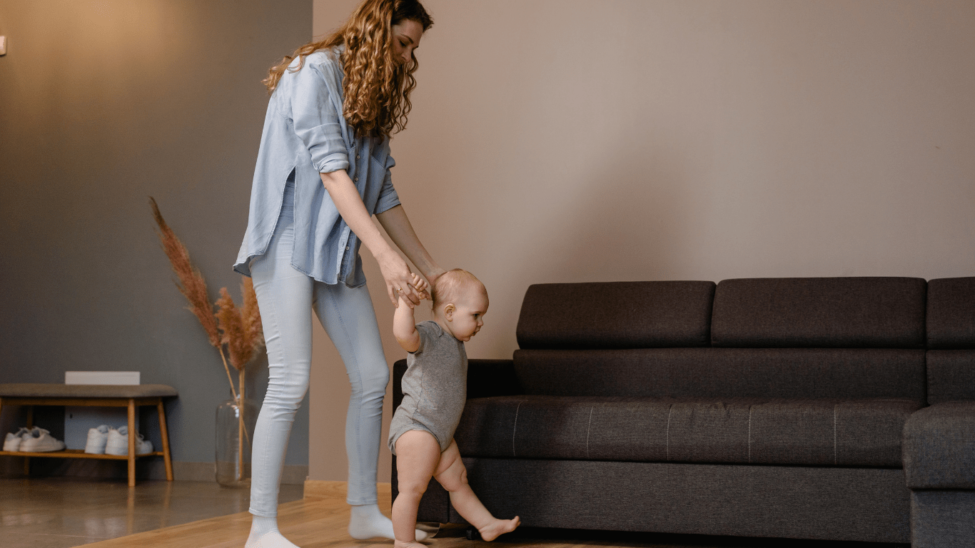 A person holding a baby while standing