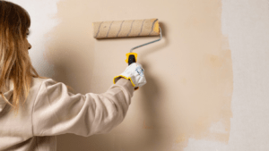 A person is painting a wall