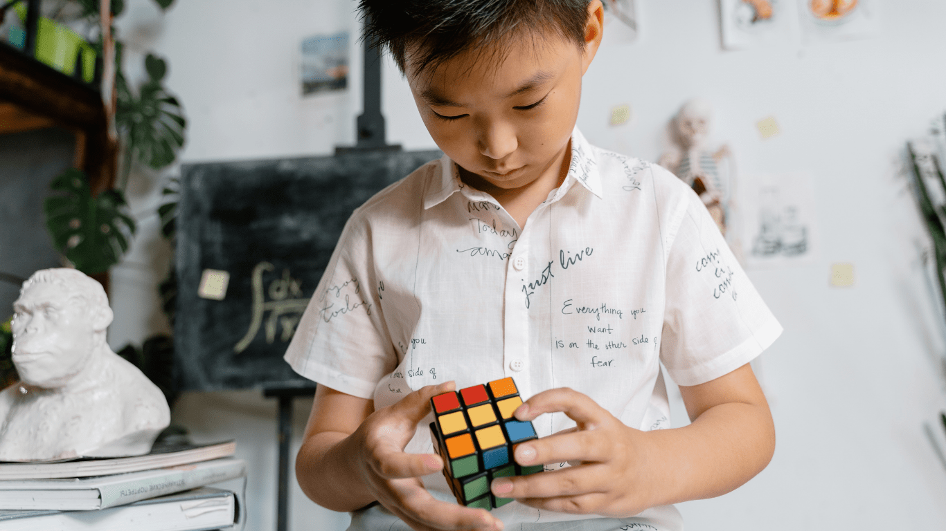 a person holding a rubiks cube