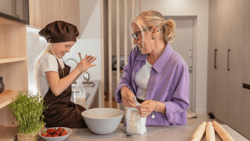 a person and child cooking in the kitchen