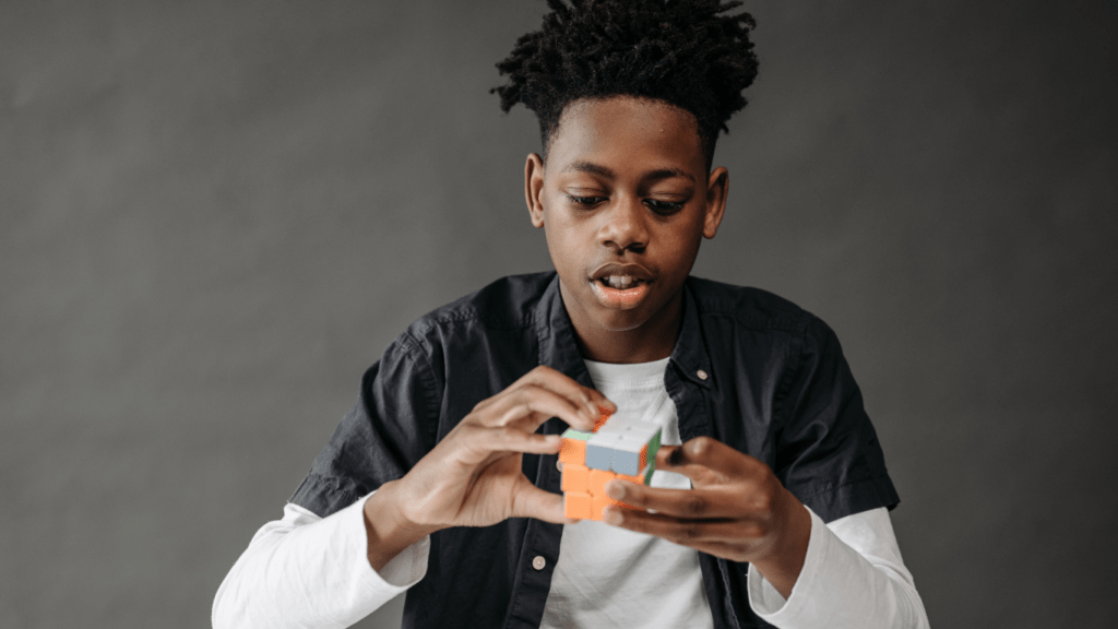 a person holding a rubiks cube