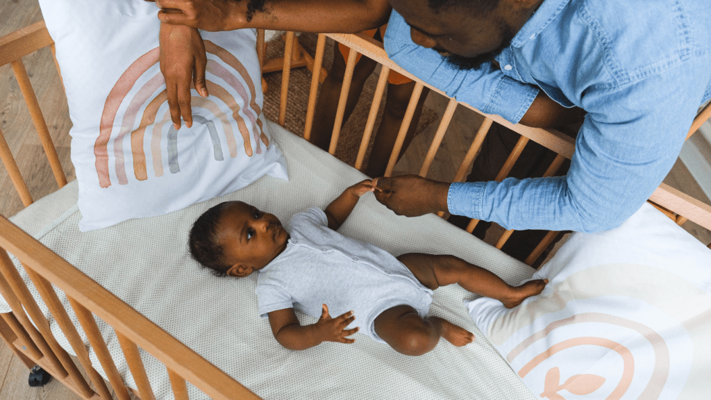 a person with a baby in a crib