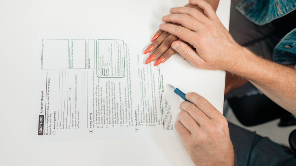 two people sitting at a table with a piece of paper in front of them