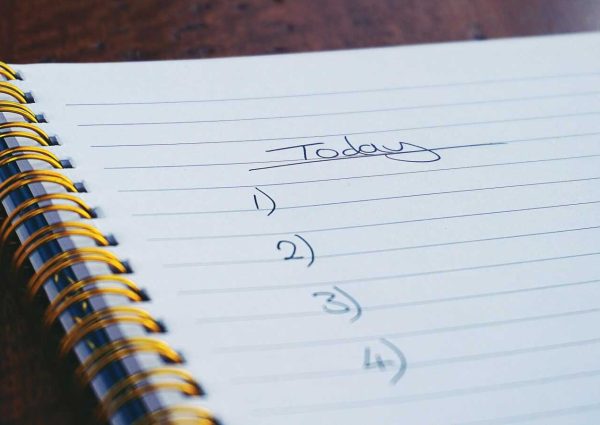 pexels-photo-1226398-1226398 A close-up view of a handwritten to-do list on a spiral notebook with numbers for tasks.
